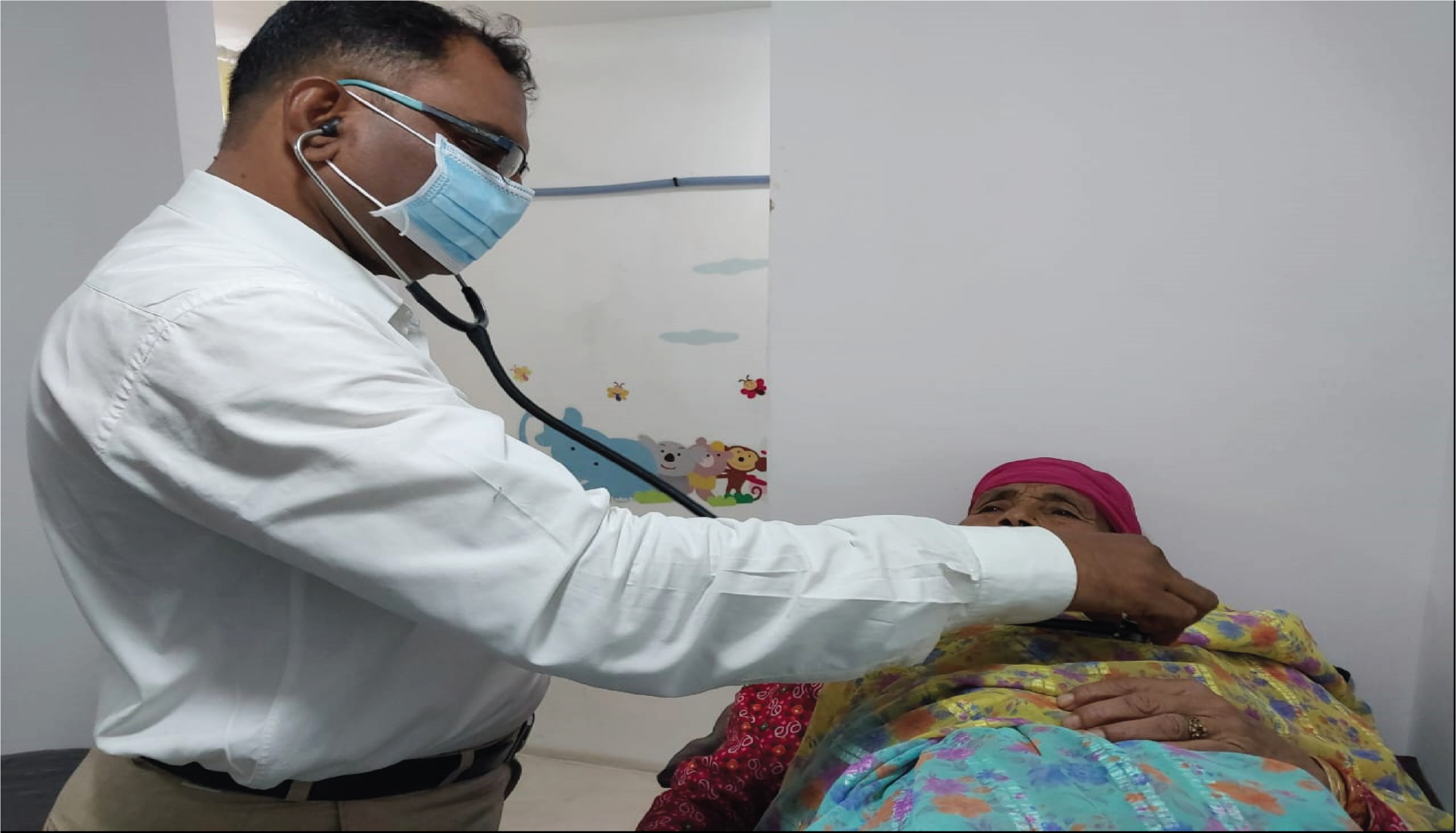 A doctor examines a child at a free health check-up camp