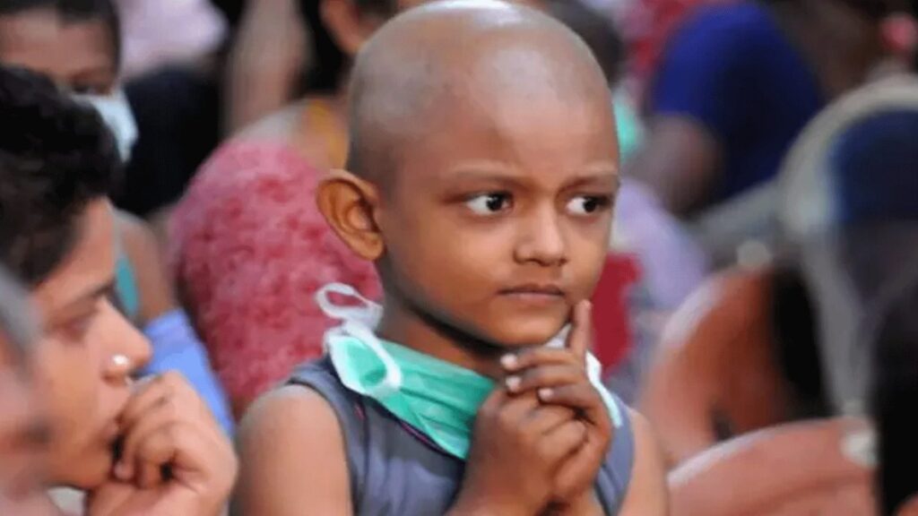 A child in treatment, thinking, with a mask around his neck